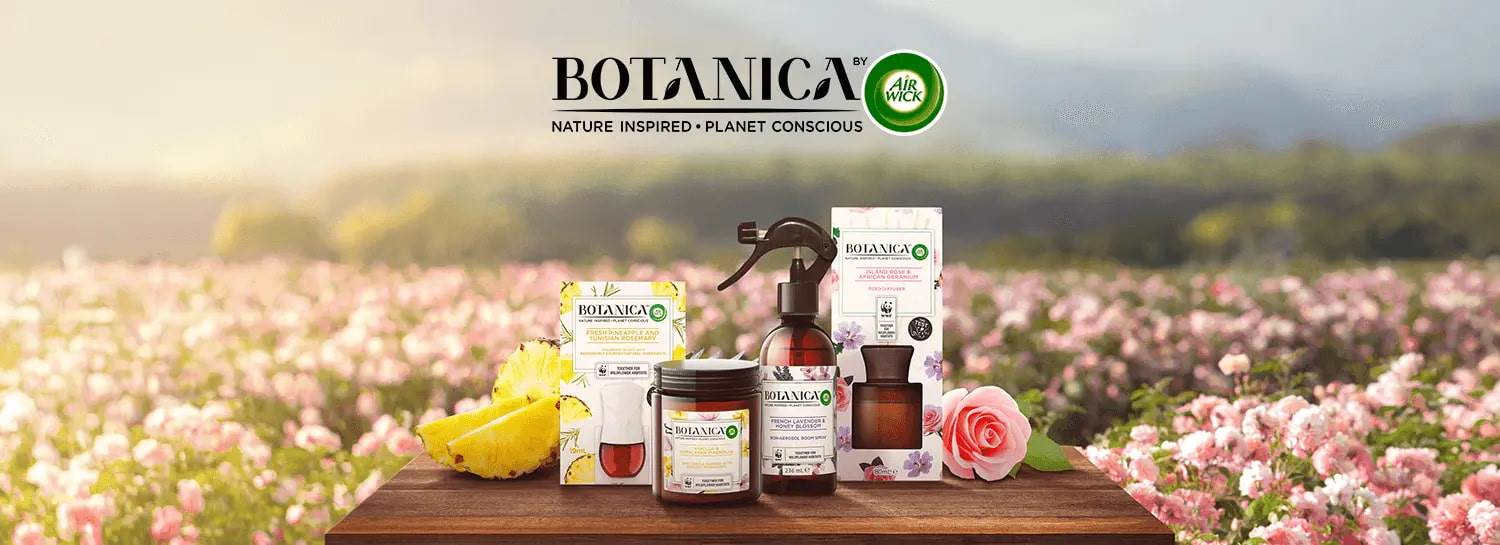 Home page banner consisting of a floral meadow backdrop, the Botanica logo and a range of Botanica products in the middle. 